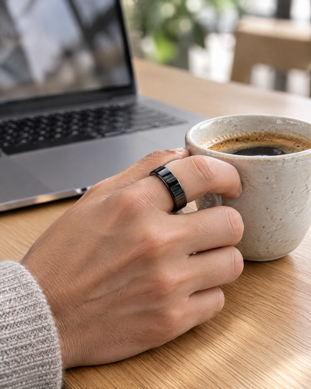 CIRCA smart ring worn while holding a coffee cup